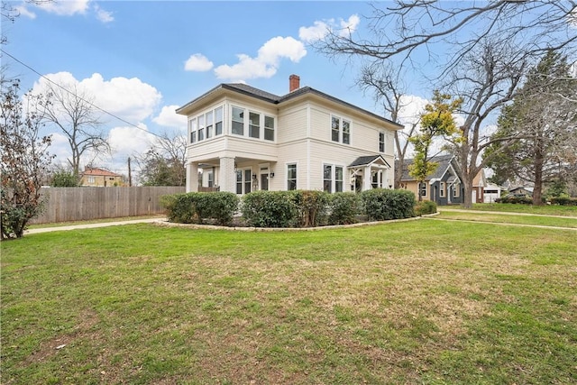 rear view of property with a yard