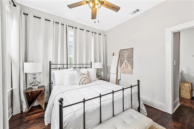 bedroom with dark hardwood / wood-style flooring and ceiling fan