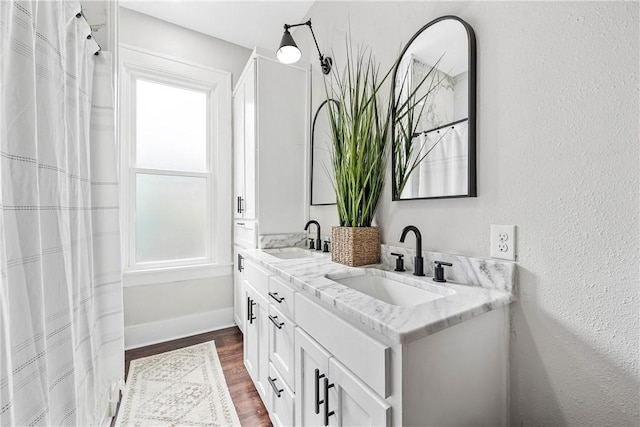 bathroom with vanity and hardwood / wood-style floors