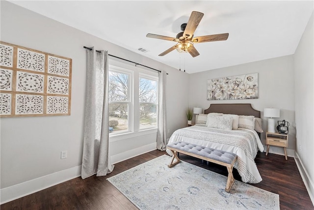 bedroom with dark hardwood / wood-style floors and ceiling fan