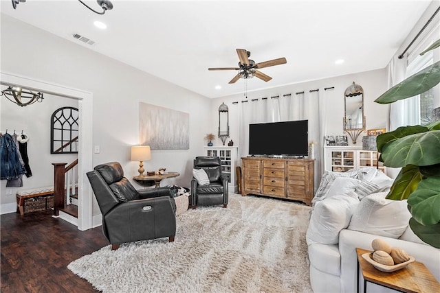 living room featuring dark hardwood / wood-style flooring and ceiling fan