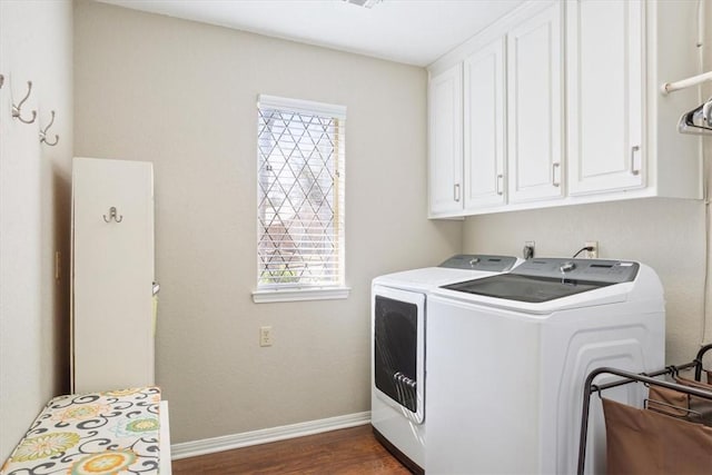 laundry room featuring cabinet space, washing machine and dryer, dark wood-style floors, and baseboards