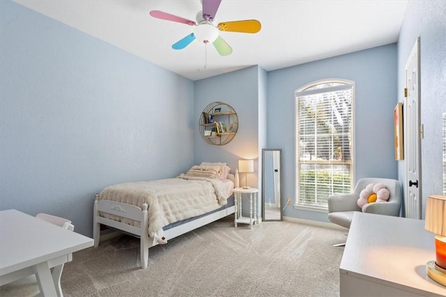 bedroom with ceiling fan, baseboards, and carpet flooring