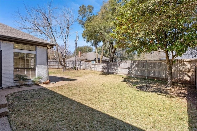 view of yard with a fenced backyard