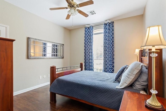 bedroom with a ceiling fan, visible vents, baseboards, and wood finished floors