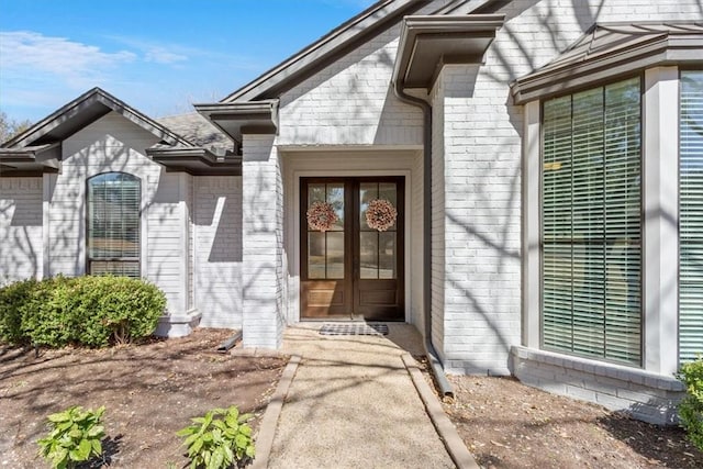 doorway to property with french doors and brick siding