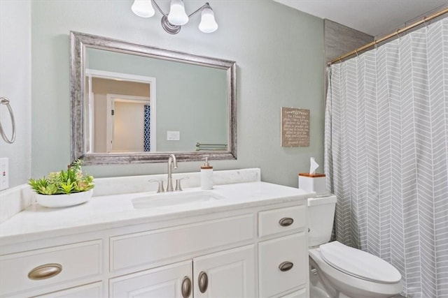 bathroom featuring toilet, curtained shower, and vanity