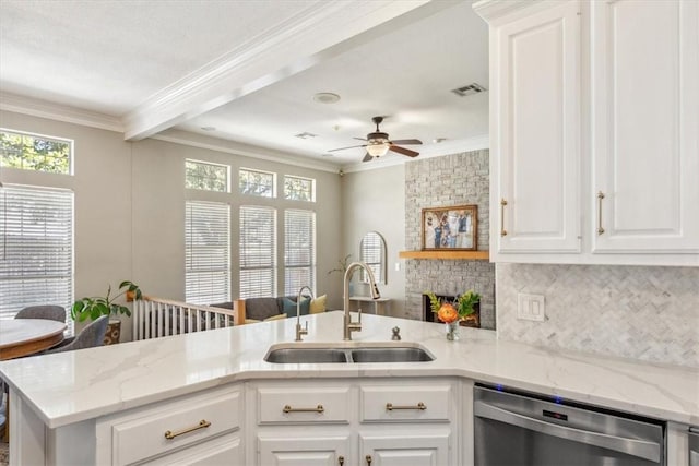 kitchen featuring tasteful backsplash, visible vents, ornamental molding, a sink, and dishwasher