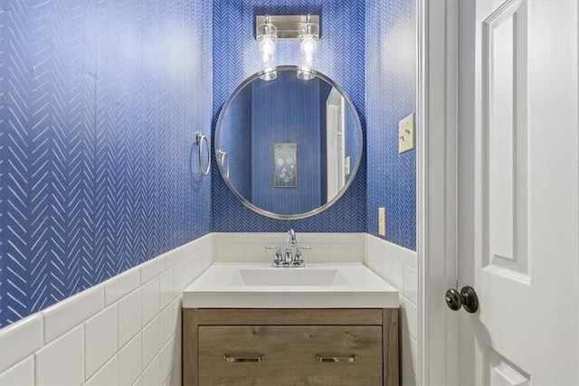 bathroom with vanity and wallpapered walls