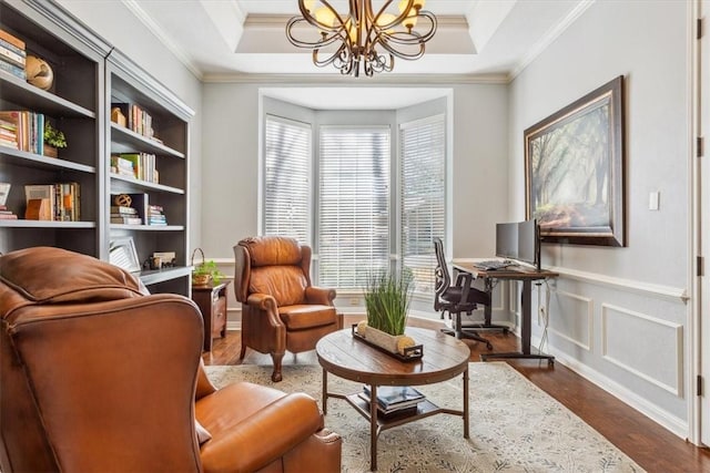 living area featuring crown molding, a chandelier, and dark wood finished floors