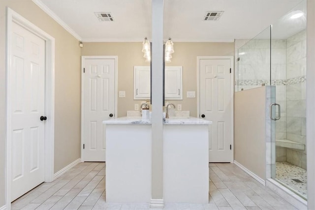 full bathroom with ornamental molding, visible vents, a shower stall, and double vanity