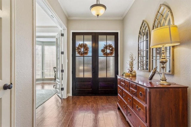 entryway featuring ornamental molding, french doors, and dark wood finished floors