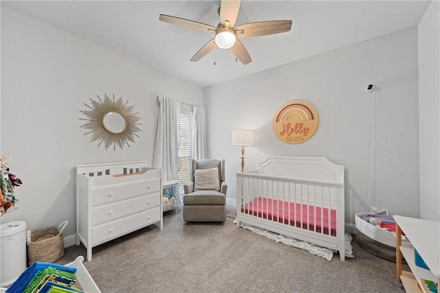 bedroom featuring ceiling fan and a crib