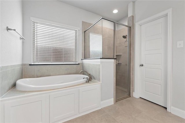 bathroom featuring tile patterned floors and shower with separate bathtub