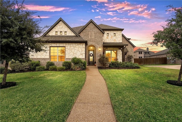 french provincial home featuring a lawn