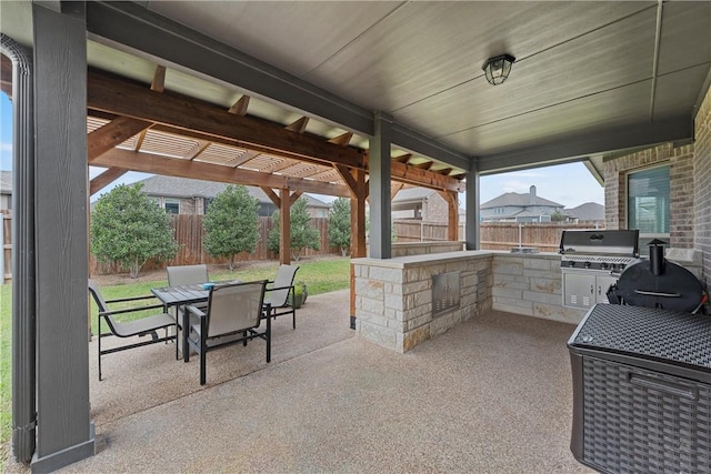 view of patio with an outdoor kitchen, grilling area, and a pergola