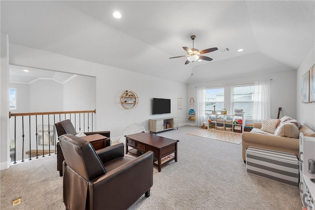 living room with ceiling fan, light colored carpet, crown molding, and vaulted ceiling