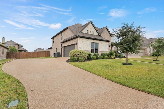 view of front of property with a front yard and central AC