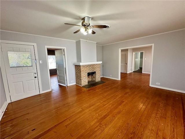 unfurnished living room with a fireplace, hardwood / wood-style flooring, ceiling fan, and ornamental molding