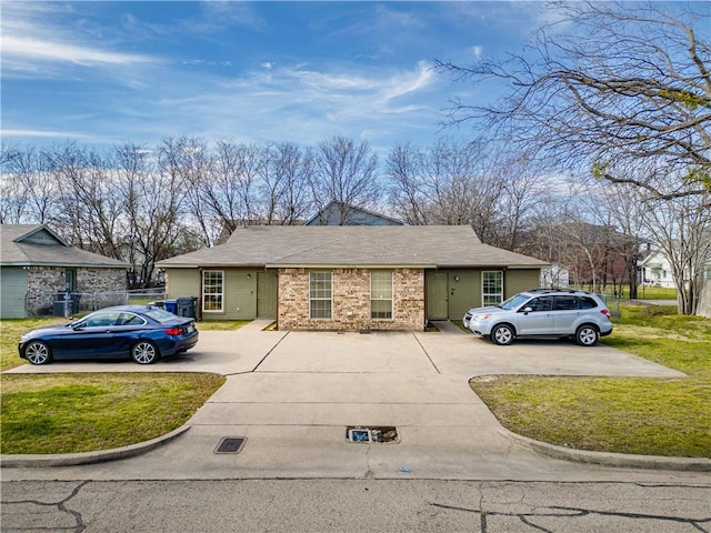 view of front of home featuring a front yard and brick siding