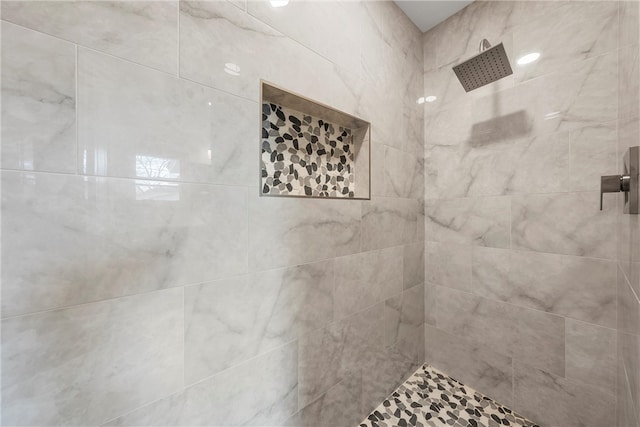 bathroom with tiled shower