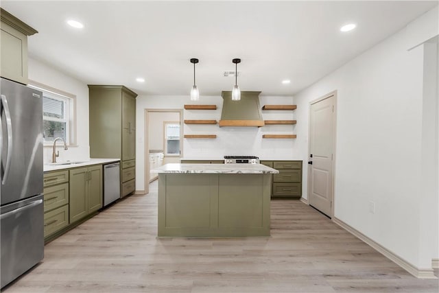 kitchen with premium range hood, open shelves, a sink, stainless steel appliances, and green cabinets