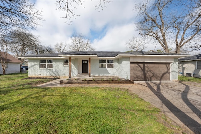 view of front of house with a front yard, a porch, an attached garage, concrete driveway, and brick siding