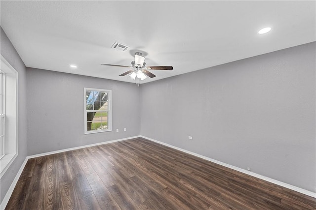 unfurnished room featuring ceiling fan and dark wood-type flooring