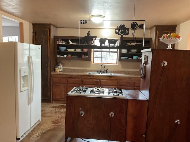 kitchen with concrete flooring, white appliances, and sink