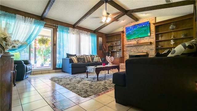 tiled living room featuring built in shelves, ceiling fan, lofted ceiling with beams, and a textured ceiling