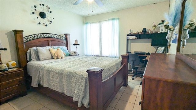 tiled bedroom with ceiling fan and a textured ceiling