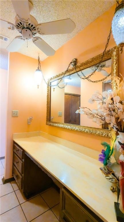 bathroom with tile patterned floors, ceiling fan, vanity, and a textured ceiling