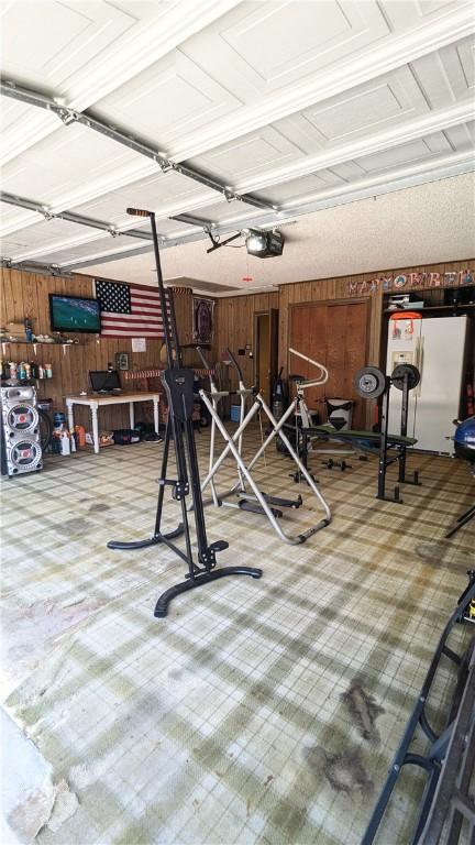 garage featuring wood walls and a garage door opener