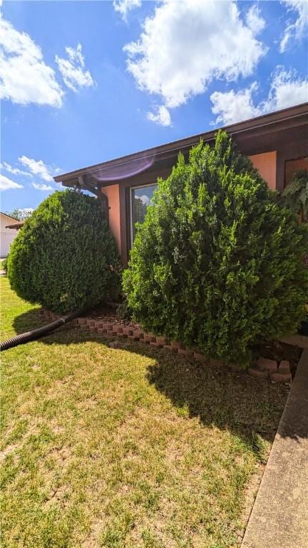 view of home's exterior with a lawn