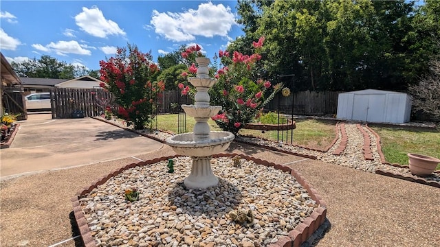 view of yard featuring a storage unit and a patio area