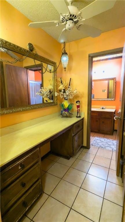 bathroom featuring tile patterned floors, vanity, ceiling fan, and a textured ceiling