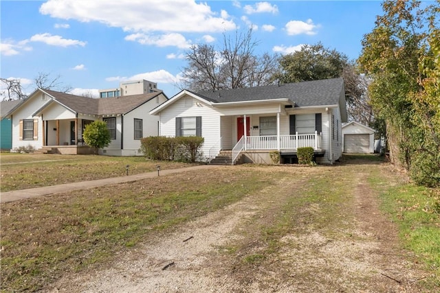 ranch-style home with a garage, a front yard, and covered porch