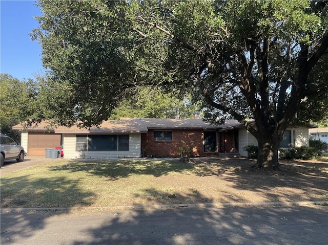 ranch-style home featuring a garage and a front lawn