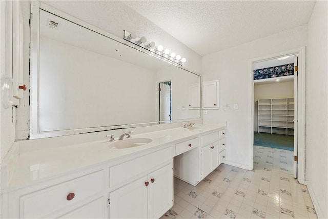 bathroom with vanity and a textured ceiling