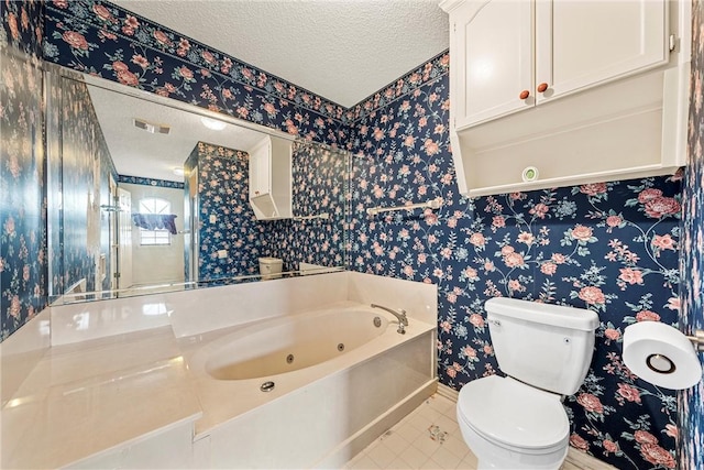 bathroom with tile patterned floors, toilet, a textured ceiling, and a washtub