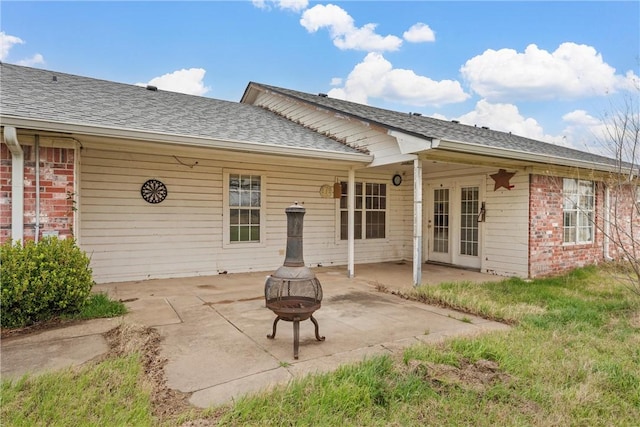 rear view of property with french doors, an outdoor fire pit, and a patio