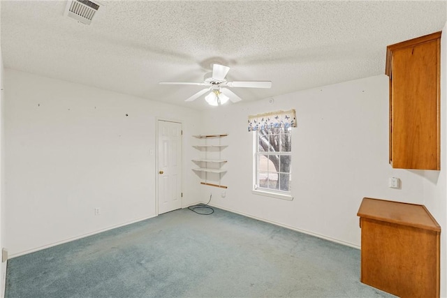 unfurnished room featuring light carpet, a textured ceiling, and ceiling fan