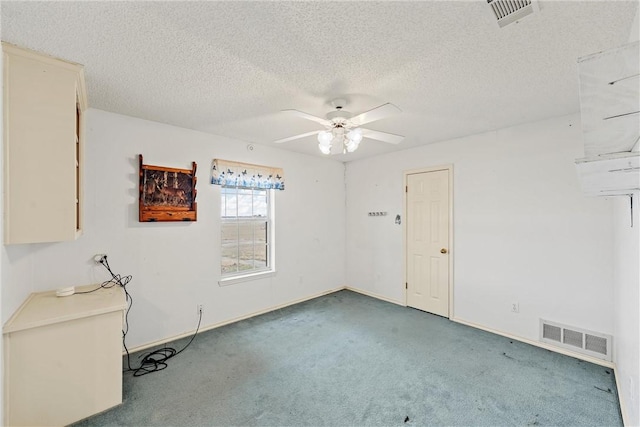 carpeted empty room with a textured ceiling and ceiling fan