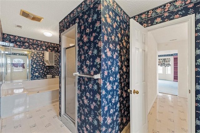 bathroom with separate shower and tub and a textured ceiling