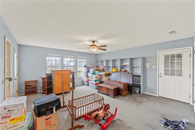 interior space with a textured ceiling and ceiling fan