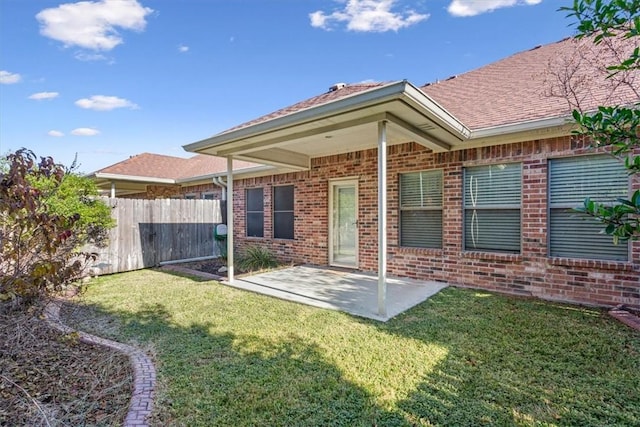 back of property featuring a yard and a patio area