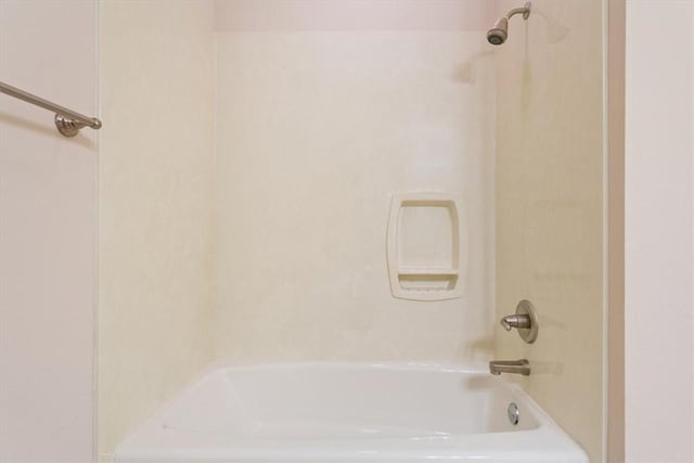 bathroom with shower / washtub combination