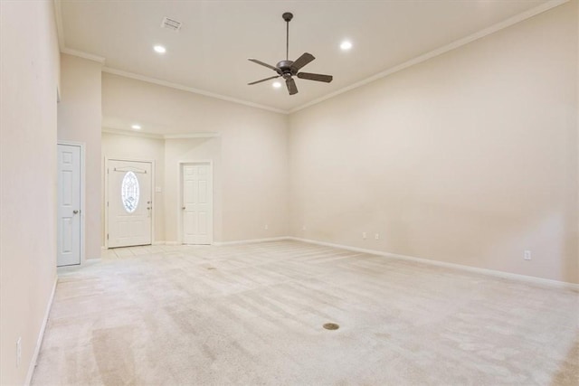 carpeted spare room with ceiling fan and ornamental molding