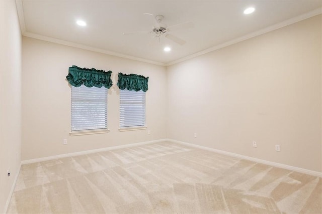 spare room with light colored carpet, ceiling fan, and crown molding