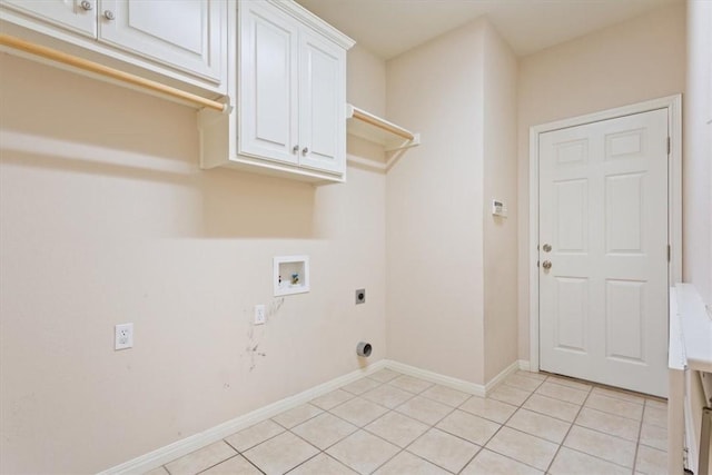 laundry room featuring electric dryer hookup, cabinets, light tile patterned floors, and hookup for a washing machine